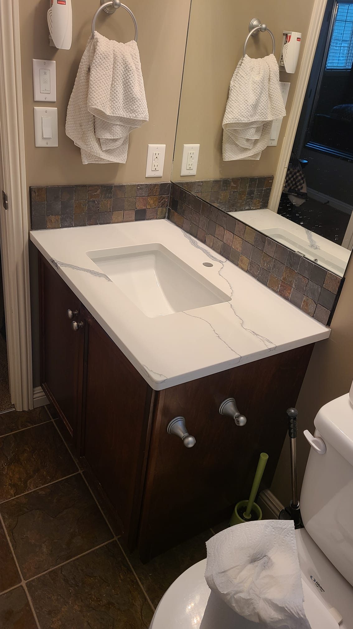 Small bathroom vanity with a new stone top and basin