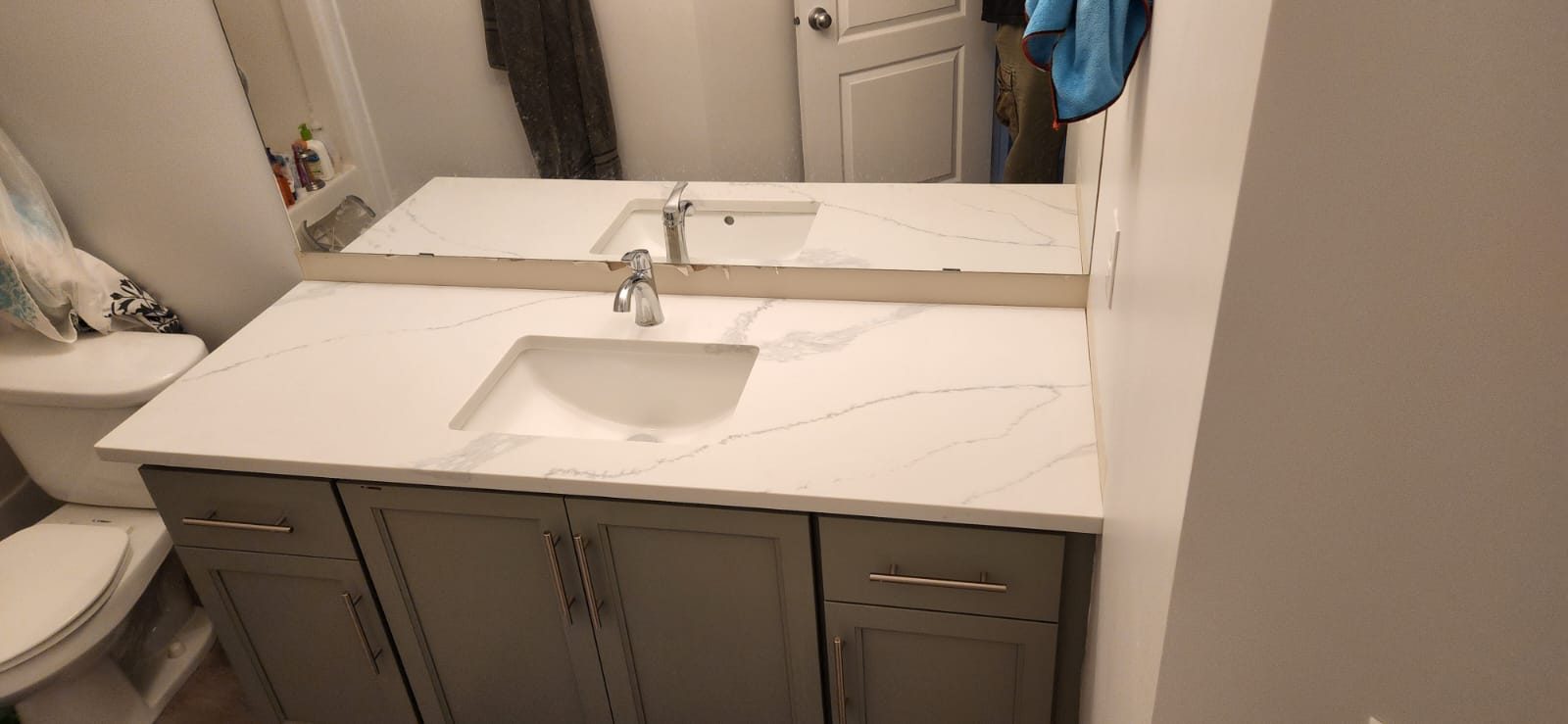 Bathroom vanity with a white quartz top and undermount basin