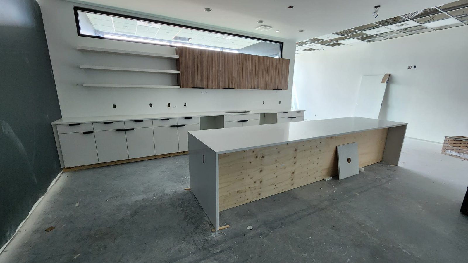 Commercial counter and cabinetry installation with a light stone surface