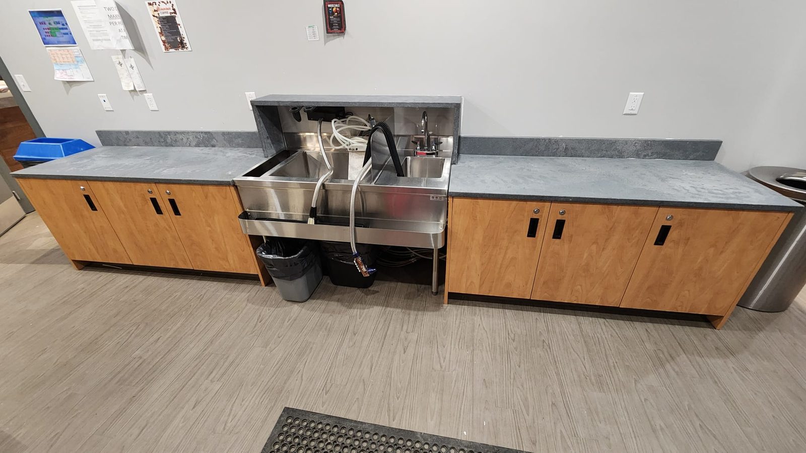 Staff kitchen with a stone counter and stainless sink