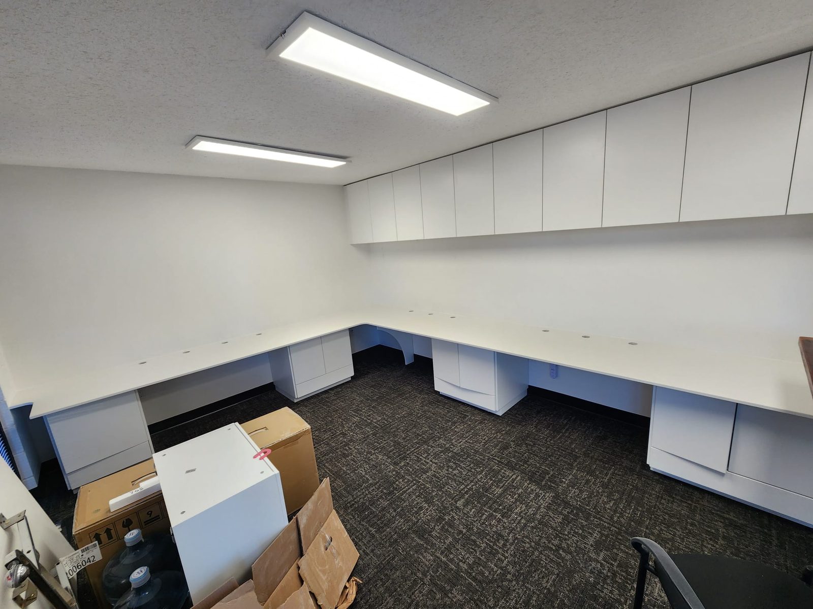 Office fit-out with continuous stone counters and storage