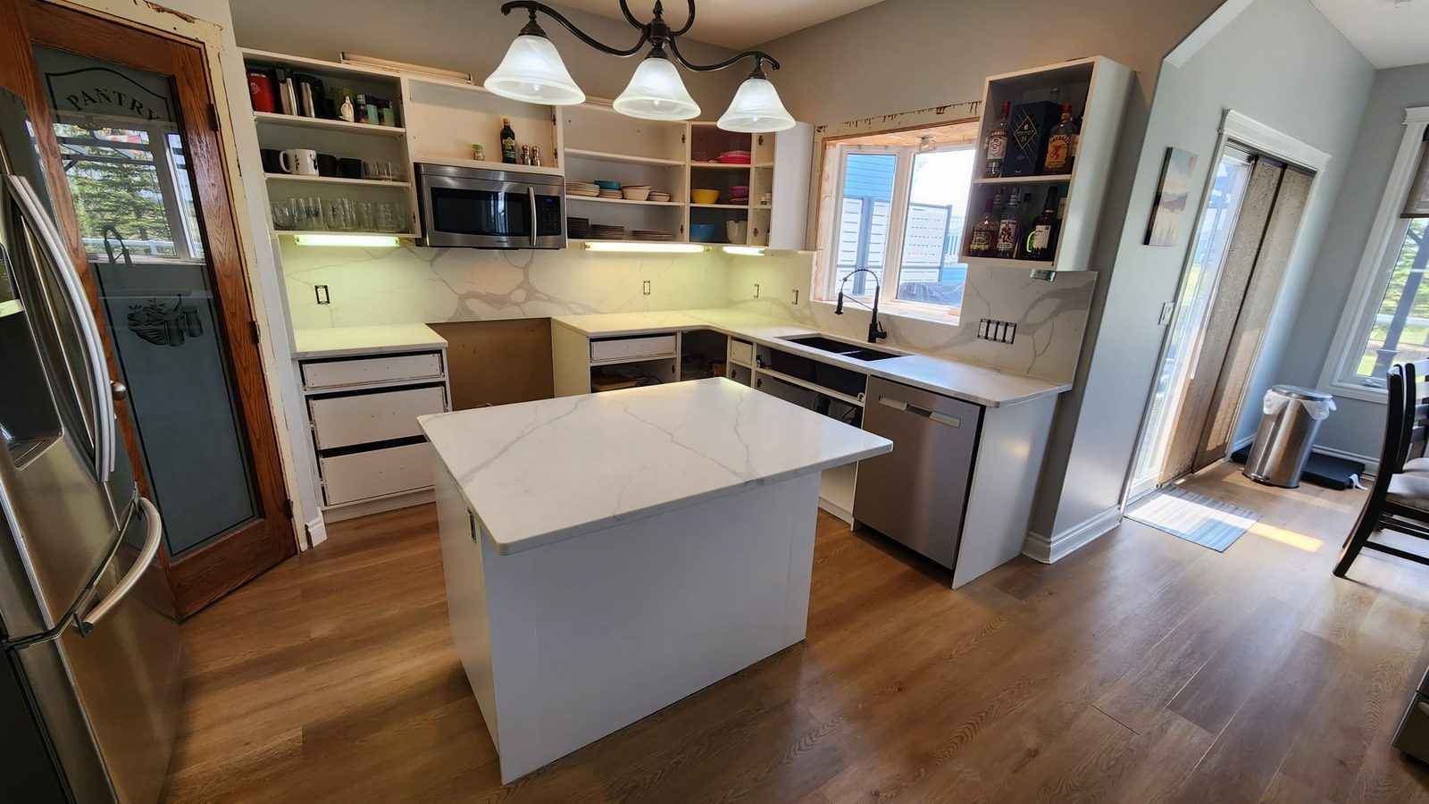 Compact kitchen with a new light stone countertop and island