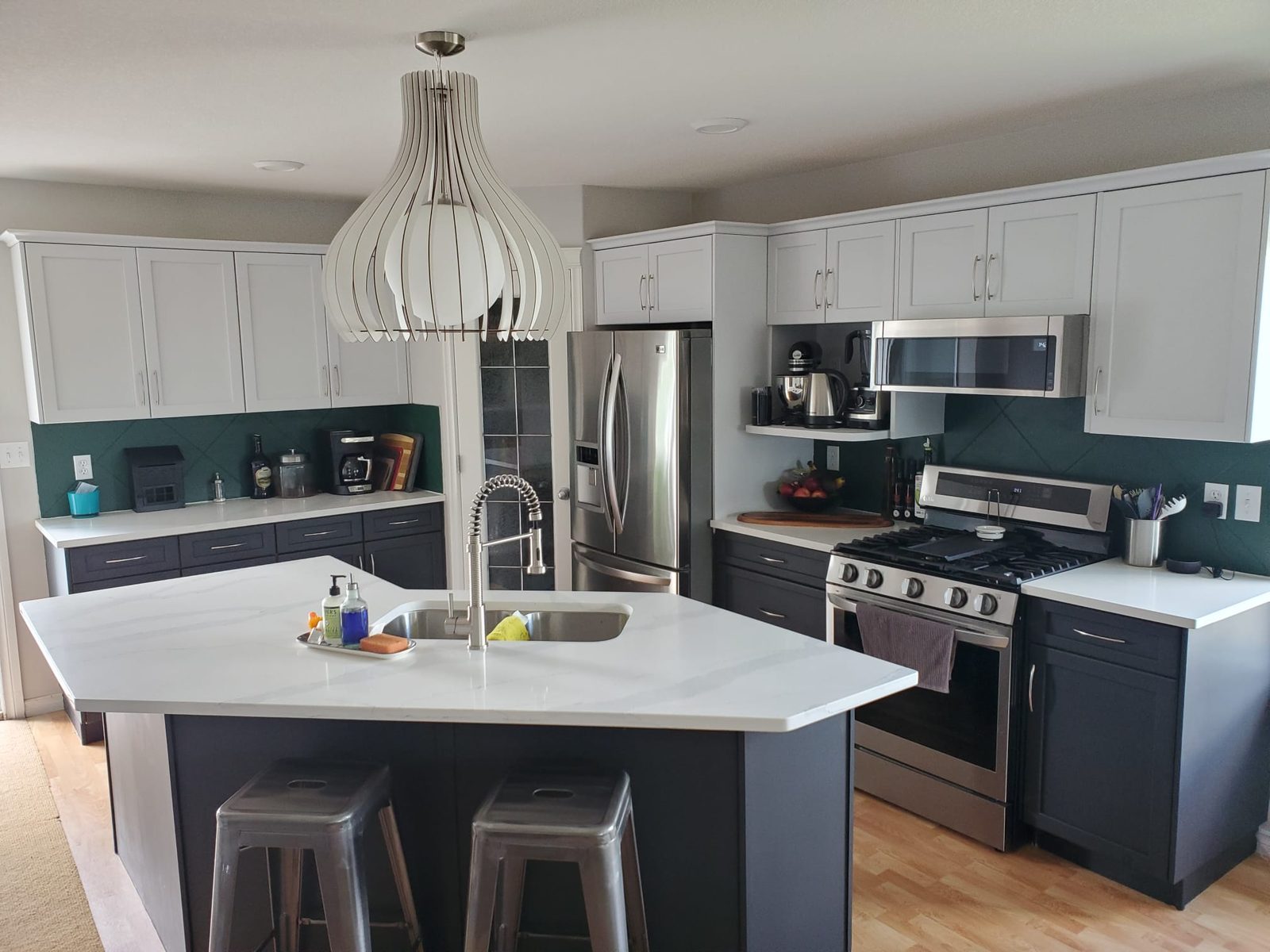 Bright kitchen with a large white quartz island and bar stools