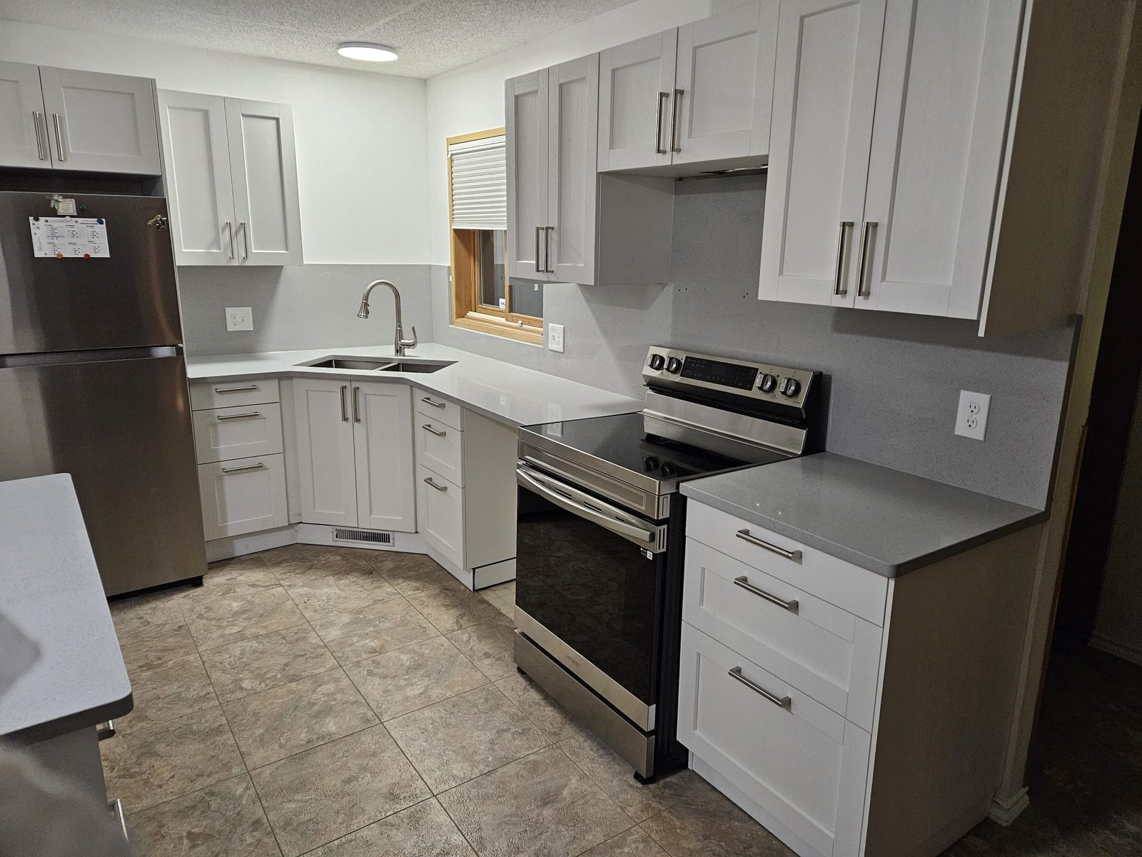 Classic white Edmonton kitchen with grey stone countertops