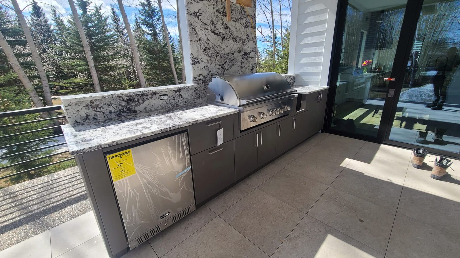 Outdoor kitchen with granite counters and a built-in grill